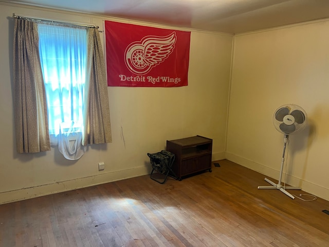 unfurnished room with hardwood / wood-style flooring