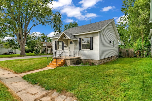 bungalow-style home featuring a front yard