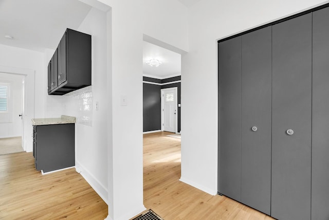 corridor with light hardwood / wood-style floors