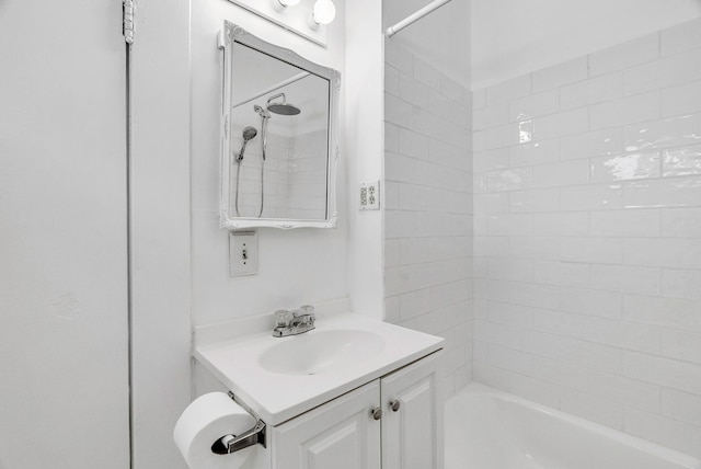 bathroom with vanity and tiled shower / bath combo