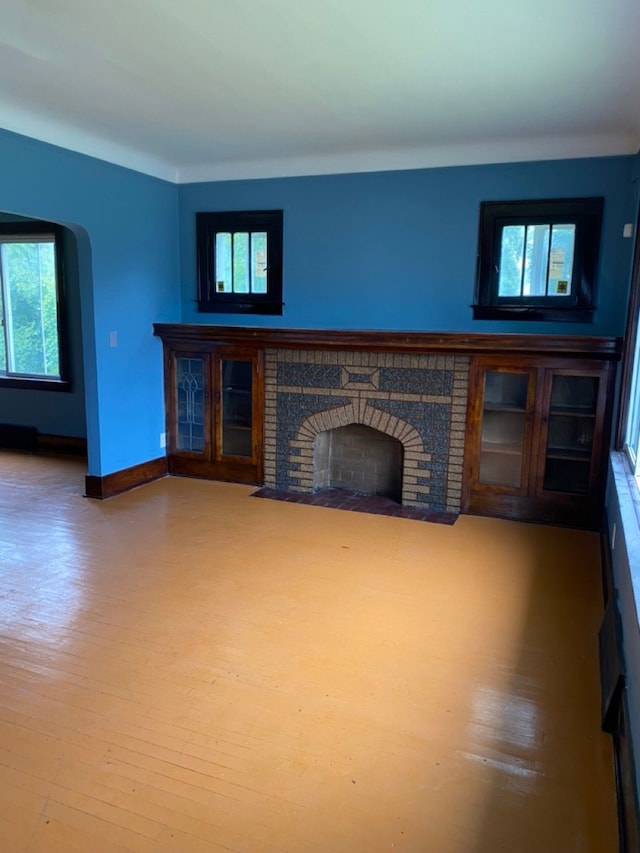 unfurnished living room with wood-type flooring and a fireplace