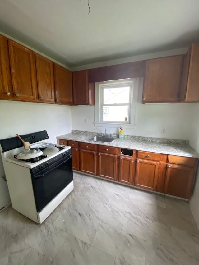 kitchen featuring sink and white stove