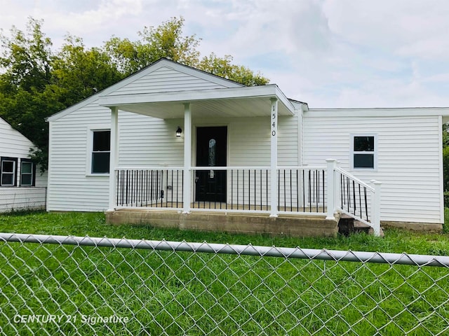 view of front facade featuring covered porch and a front yard