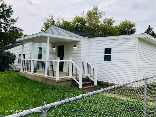 rear view of property with a lawn