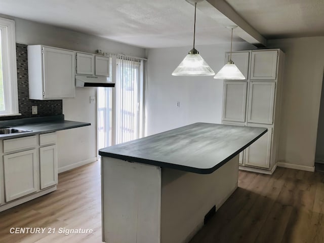 1540 Pound Dr, Flint, MI 48532 - kitchen with healthy amount of natural light, light wood-style floors, tasteful backsplash, and beam ceiling