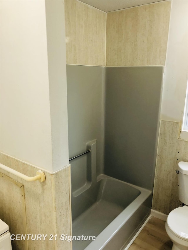 1540 Pound Dr, Flint, MI 48532 - full bathroom featuring toilet, a shower, and wood finished floors