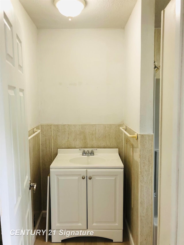 bathroom with vanity and a textured ceiling