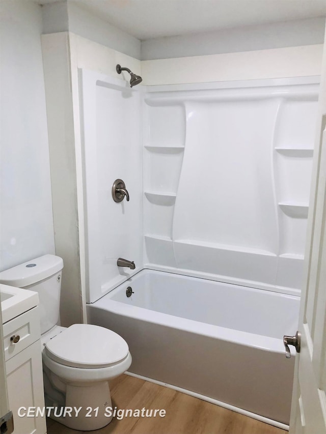 full bathroom with washtub / shower combination, toilet, wood-type flooring, and vanity