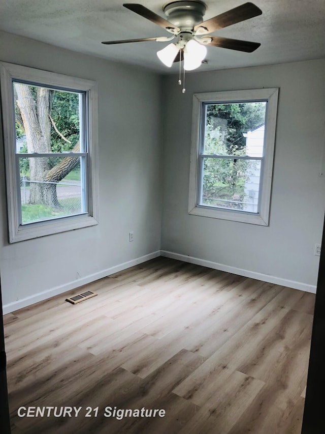 1540 Pound Dr, Flint, MI 48532 - spare room featuring ceiling fan, light wood-type flooring, and baseboards