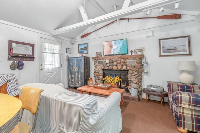 carpeted living room with vaulted ceiling with beams and a stone fireplace
