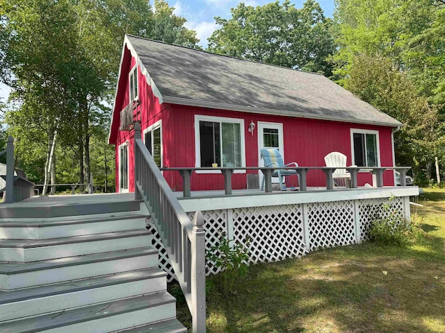 exterior space with a front yard and a deck