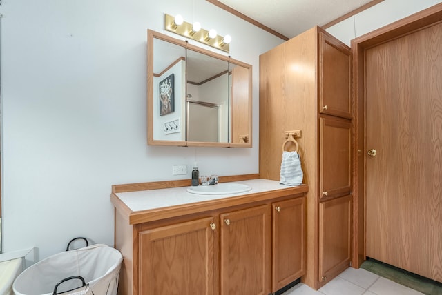 bathroom featuring tile patterned floors, ornamental molding, a textured ceiling, vanity, and a shower with door