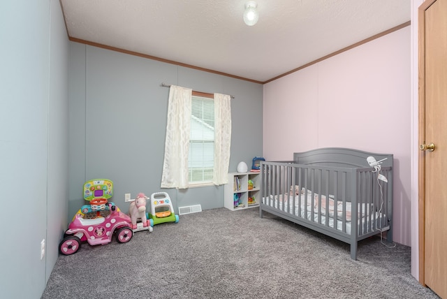 bedroom featuring crown molding, carpet floors, and a crib