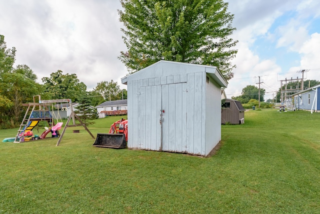 view of outdoor structure with a playground and a yard