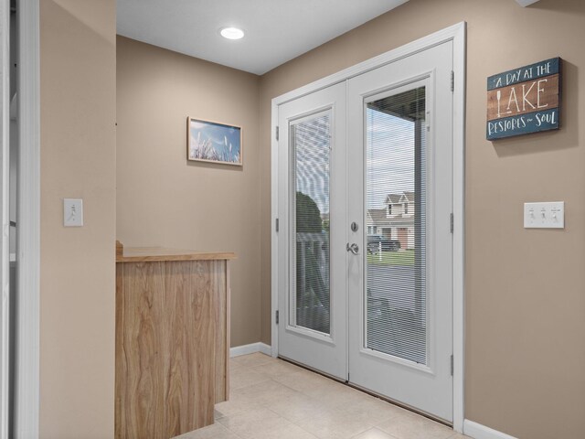 94 Charter Ct, Manistee, MI 49660 - doorway featuring french doors, baseboards, a dry bar, tile patterned flooring, and recessed lighting