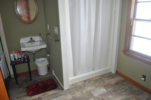 3329 120th Ave, Holland, MI 49424 - bathroom with baseboards, wood finished floors, a sink, and a shower stall
