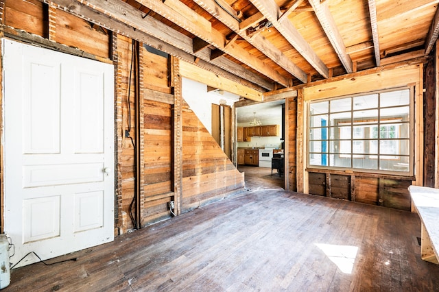 interior space with wood walls and dark wood-type flooring