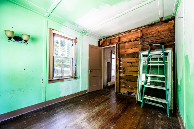 unfurnished bedroom with dark wood-type flooring