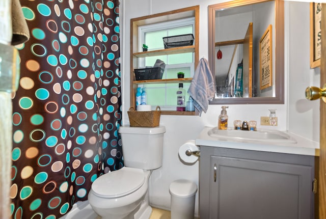 bathroom with vanity, toilet, and walk in shower