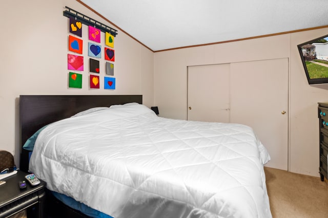 bedroom featuring ornamental molding, carpet floors, a closet, and lofted ceiling