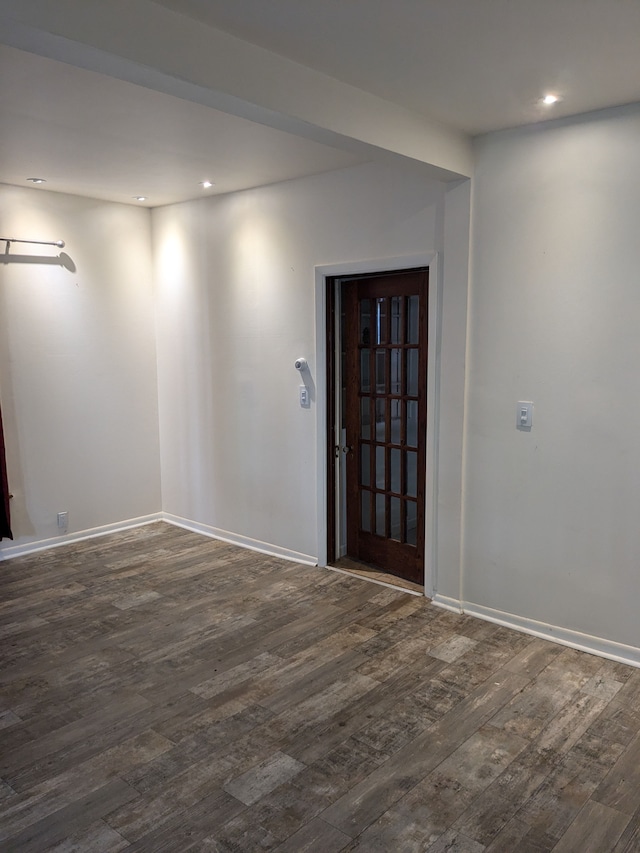 unfurnished room featuring dark wood-type flooring