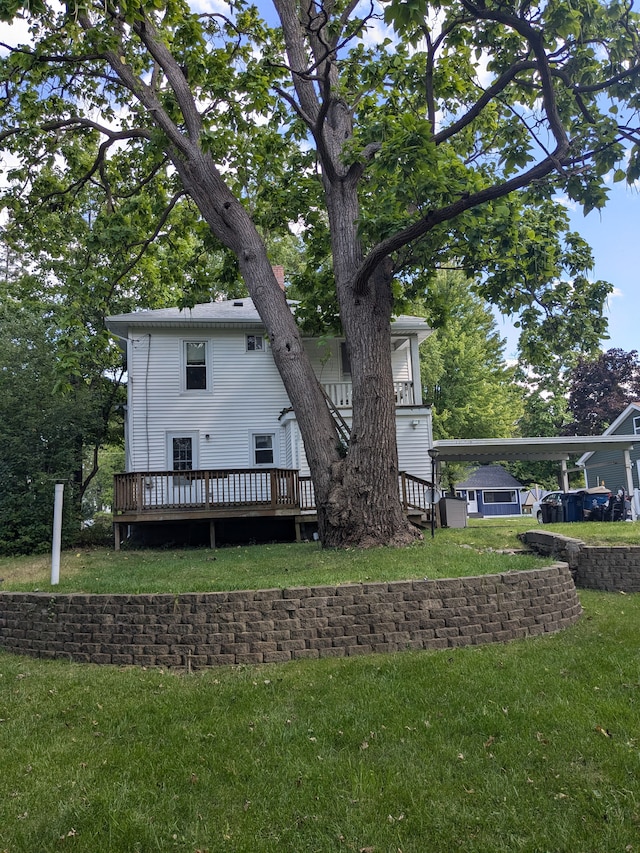 rear view of house with a yard and a wooden deck