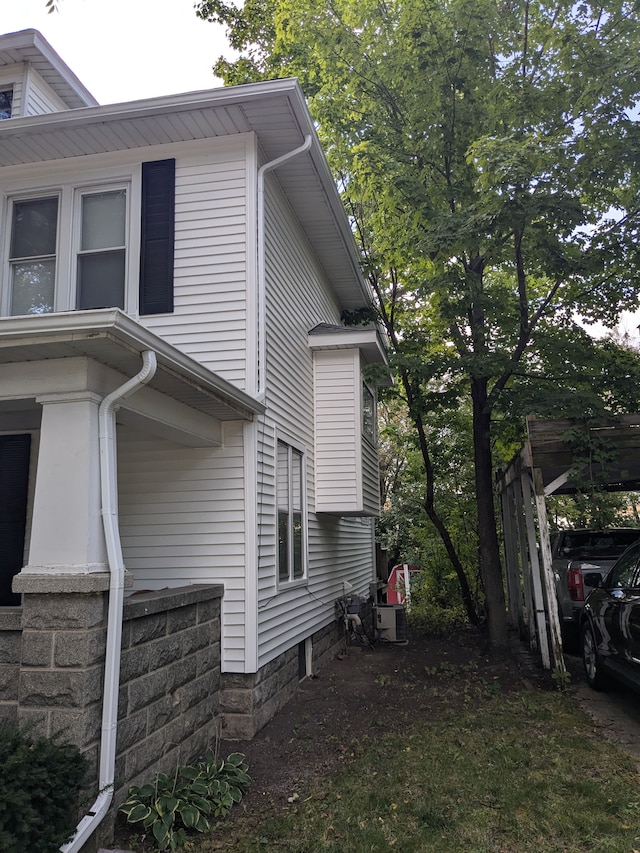 view of side of home with a carport