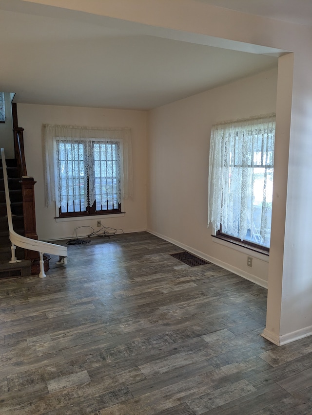 unfurnished living room featuring dark hardwood / wood-style floors