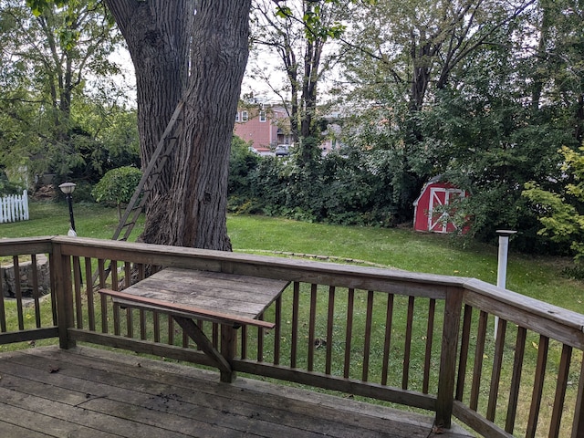 wooden terrace with a lawn and a shed