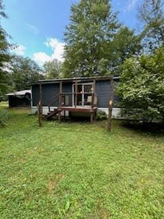 back of property featuring a lawn