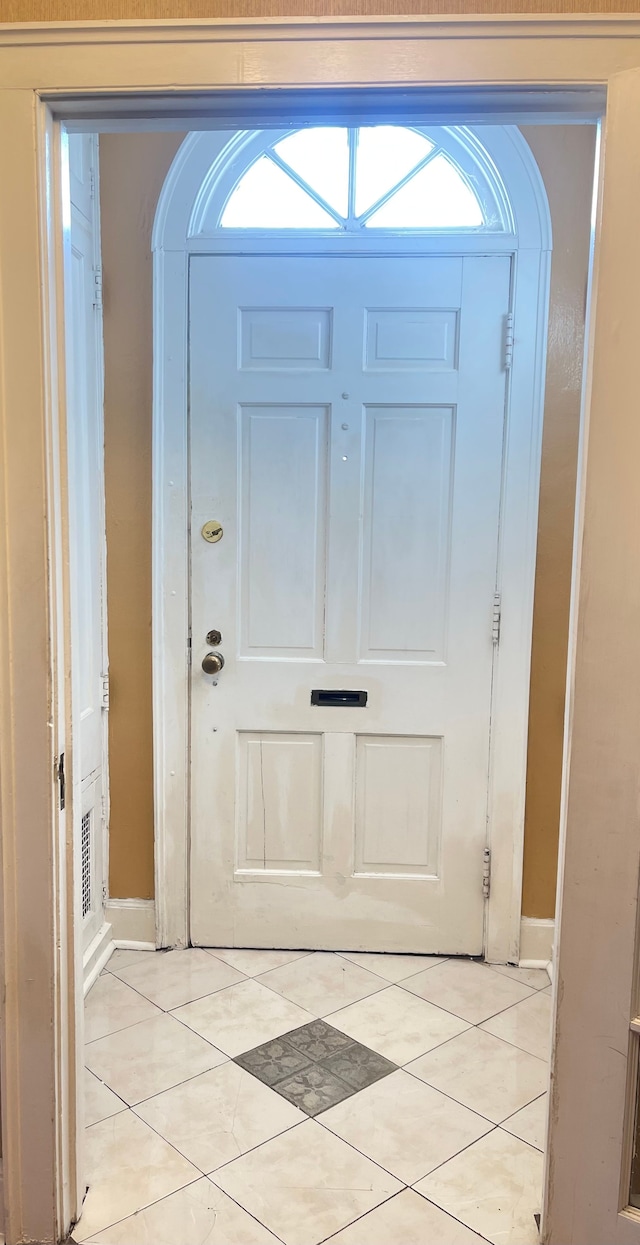 entryway with light tile patterned floors