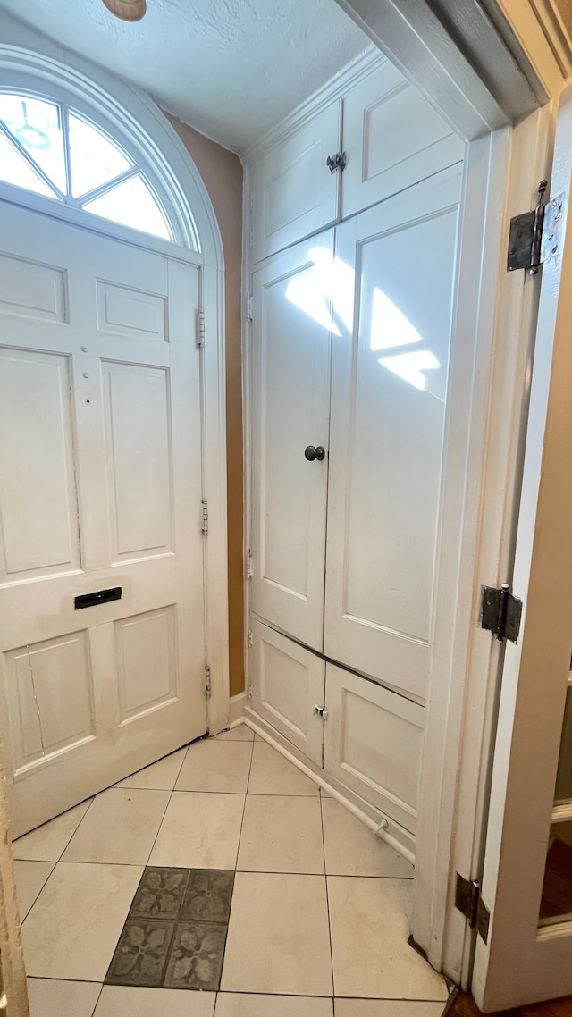 doorway with light tile patterned floors