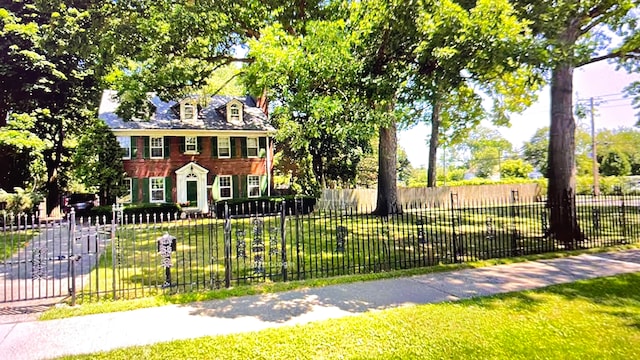 colonial inspired home with a front lawn