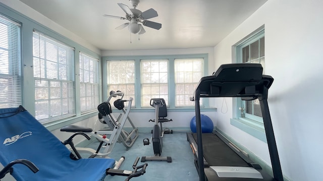 exercise room with ceiling fan and a wealth of natural light