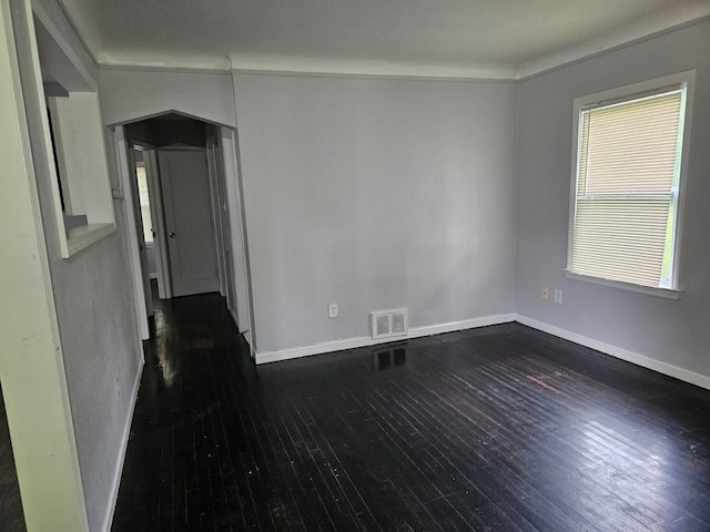 unfurnished room featuring lofted ceiling, dark hardwood / wood-style floors, and a healthy amount of sunlight