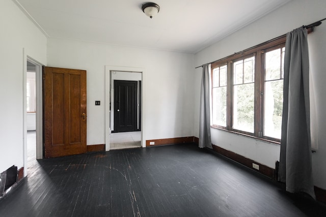 spare room featuring dark hardwood / wood-style flooring