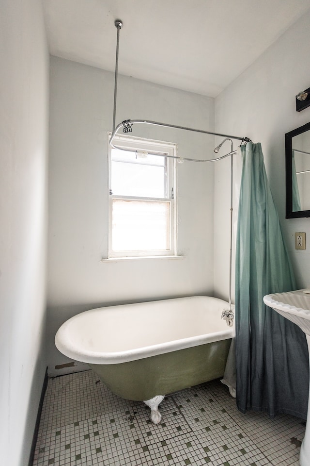 bathroom featuring tile patterned flooring and shower / bath combo