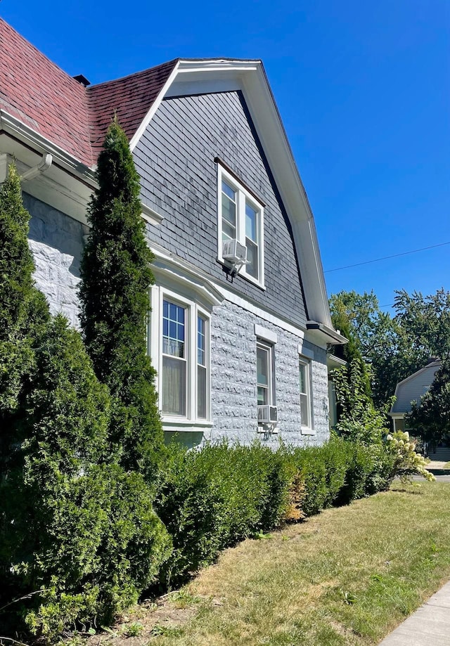 view of property exterior featuring a yard and cooling unit