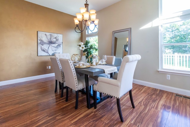 dining room with a chandelier and dark hardwood / wood-style floors