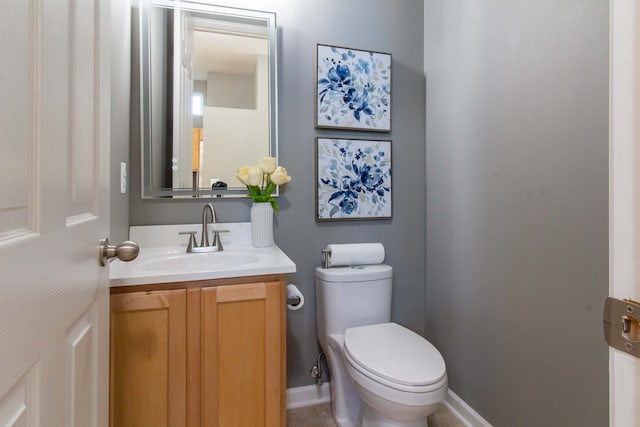 bathroom featuring tile patterned flooring, vanity, and toilet