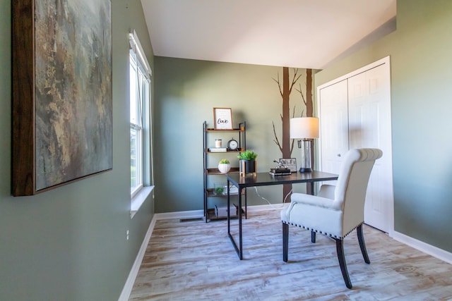 office space featuring light wood-type flooring and a wealth of natural light