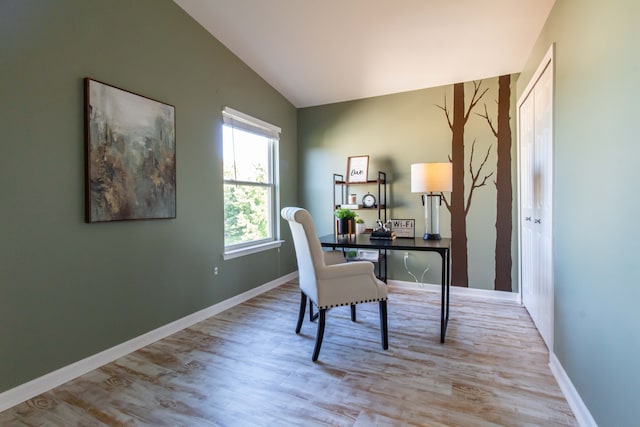 office featuring vaulted ceiling and light hardwood / wood-style flooring