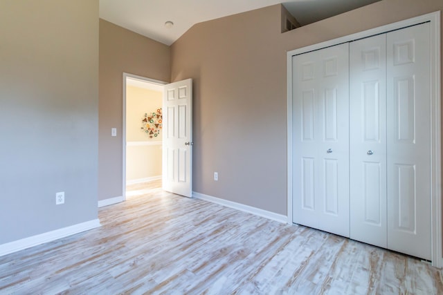 unfurnished bedroom featuring a closet and light hardwood / wood-style flooring