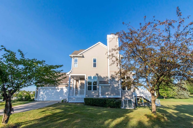 view of front of house with covered porch, a garage, and a front lawn