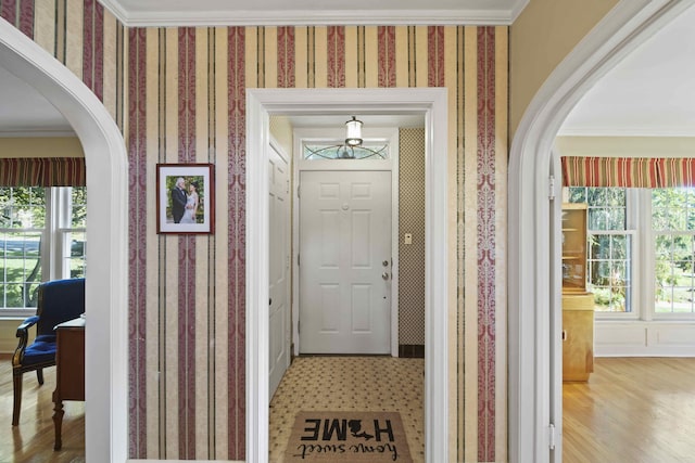 foyer entrance with hardwood / wood-style flooring and ornamental molding