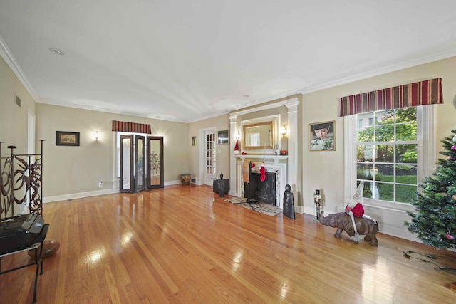 living room featuring ornamental molding and light hardwood / wood-style flooring