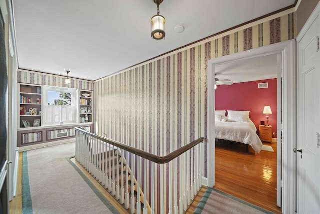 hallway with hardwood / wood-style floors