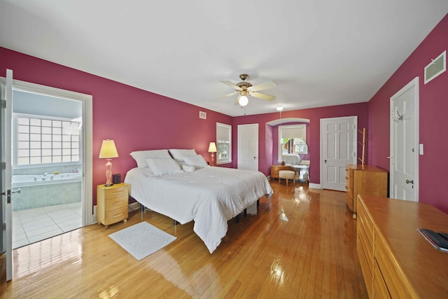 bedroom featuring ceiling fan, wood-type flooring, and ensuite bathroom