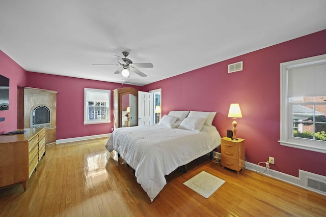 bedroom with hardwood / wood-style floors and ceiling fan