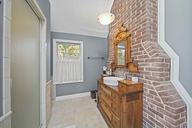 bathroom featuring a shower with door and vanity